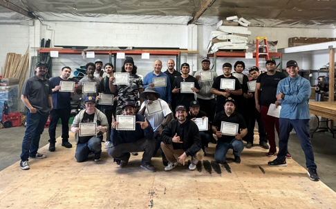Image of BYLTup team in the workshop holding certifications after completing training.