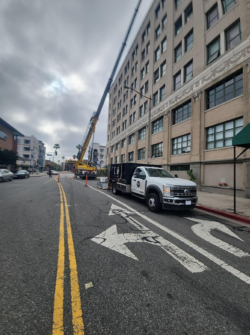 Street view of BYLTup truck and crane in front of the Kress Lofts
